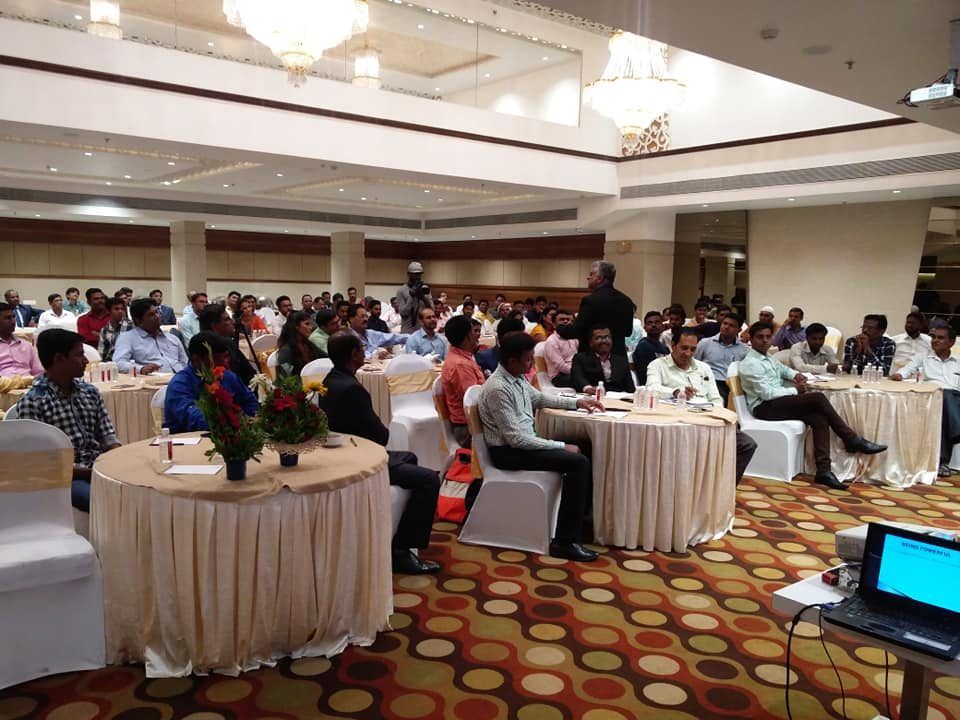 Banquet-hall workshop with participants at round tables